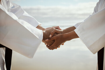 Canvas Print - Martial arts, people and karate on beach for fitness, teaching and respect with handshake or thank you. Sensei, student and shaking hands by ocean for self defense class, gratitude and discipline