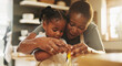 © AzeemudDeen/peopleimages.com - Education, child and black woman in kitchen for baking, recipe or help cracking egg at home. Girl, development and mother at counter for growth, learning or fun activity for making dough for cookies