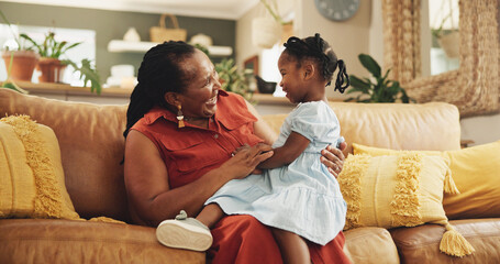 Sticker - Happy, black woman and fun with child at house for bonding, love and care together of family support on sofa. Smile, grandmother and girl relax on sofa for playful, trust and connection in lounge