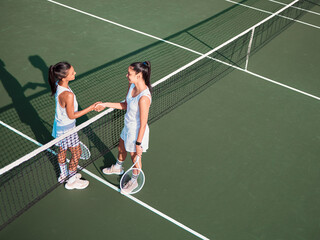 Wall Mural - Court, tennis and women with handshake for sports, competition and game challenge with thank you. Outdoor, athletes or people with shaking hands after match, training and well done for tournament