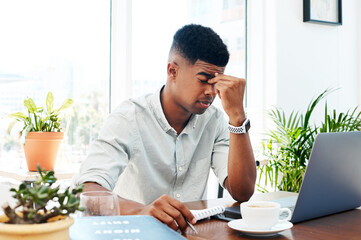 Poster - African man, laptop and headache in modern office with stress, deadline or migraine for project at startup. Person, writer and tired by pc, exhausted and pain with editing process at creative agency