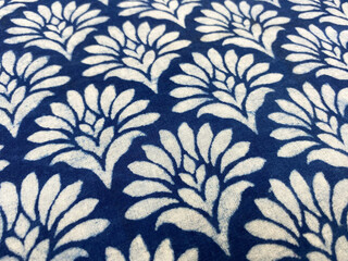 close up view of Traditional floral design in indigo block printed fabric of india, dabu print of jaipur