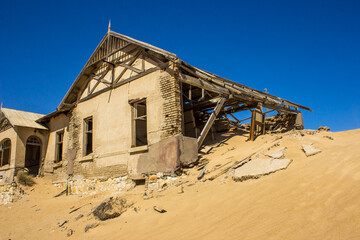 The old schoolmasters house, buried by a sand dune, in the abandoned diamond mining Town of Kolmanskuppe.