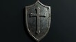 © visual artstock - A weathered metal shield with a cross embossed on it, isolated on black.