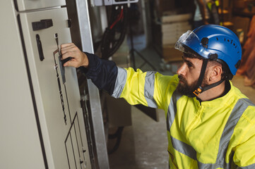 engineering technician Setting up the solar panel inverter in the electrical room Service engineer installs solar cells on factory roofs Concept of clean energy and renewable energy