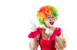 © TSViPhoto - Funny female clown pointing at blank template copy spase for advertising, posters, greetings, invitations. Entertainer as Joker in a suit and wig, with clown whiteface makeup.