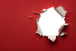 © graphicbeezstock - ripped transparent hole in red paper copy space for text, torn hole