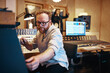 © Flamingo Images - Music producer adjusting levels during a session in his studio
