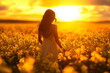 © Liza - woman standing in a field against the backdrop of a sunset