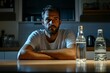 © Mikki Orso - Man at kitchen table contemplating alcohol vswater  lifestyle choices and decisions