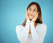 © KayJoint/peopleimages.com - Happy, woman and thinking with shy, smile and hands to face with idea about love in studio. Gen z, memory and gratitude of a young person from Brazil with casual fashion style and blue background