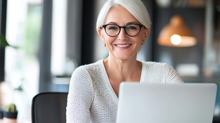 a woman with glasses on is looking at a laptop