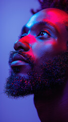 Wall Mural - Portrait of man with beard looking up in colorful lighting