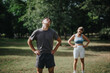 © qunica.com - Two individuals engage in calisthenics exercises outdoors in a park setting, enjoying a healthy workout routine.