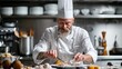 © Рудой Максим - A skilled chef meticulously plating a gourmet dish in a professional kitchen during dinner service