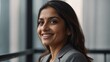 © Heruvim - Smiling woman in grey suit near window with bindi