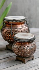 Canvas Print - Ornate copper drums with intricate designs.