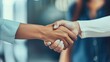 © AkuAku - Businesswoman shaking hands in the office to seal a deal teamwork and gratitude between female colleagues
