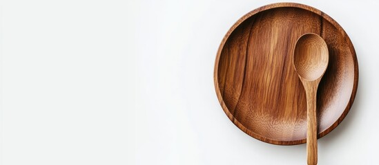 Poster - An empty wooden spoon and plate on a white background featuring wooden dishware and tableware. with copy space image. Place for adding text or design