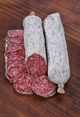 Wall Mural - traditional Spanish salami fuet sausage or dry sausage cut in slices in a kitchen table.