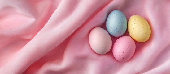 Poster - Colorful Easter eggs on a pink fabric background Top view flat lay. with copy space image. Place for adding text or design