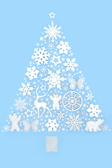 Wall Mural - Christmas tree shape surreal fantasy decorative design concept with frosted white ornaments North Pole theme on blue background. Festive fun abstract composition.