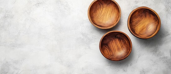 Poster - Empty Wooden Bowl set with copyspace for text or food viewed from above on a white stone table background