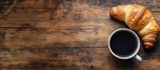 Poster - Coffee and croissant on a rustic wooden table French breakfast Top view Flat lay Copyspace