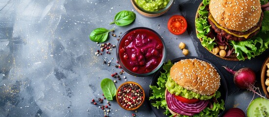 Vegan beet and chickpea burger with vegetables guacamole and a rye bun accompanied by green juice Healthy vegan food idea. with copy space image. Place for adding text or design