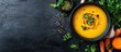 © vxnaghiyev - Healthy food and clean eating concept Creamy pumpkin and carrot soup made with seasonal spicy fall vegetables accompanied by ingredients on a table Copy space background