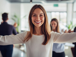 Joyful woman with outstretched arms, smiling brightly in a casual setting, representing happiness, positivity, and social connection.