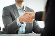 © peopleimages.com - Business people, man and woman with handshake, closeup and client with deal, contract and partnership. Office, interview and promotion with attorney, legal aid and shaking hand for welcome and lawyer