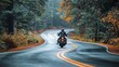 © Kan - A motorcyclist rides through a winding road surrounded by autumn trees, capturing the essence of adventure and freedom.