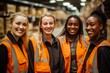 © NikoG - Smiling portrait of a young and diverse group of women in warehouse