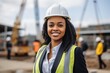 © NikoG - Smiling portrait of a young female African American architect on construction site