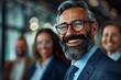 © Vera - Laughing business professionals wearing eyeglasses and one individual with a well-groomed beard.