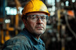 © Peter - Dedicated middle-aged worker in a steel plant, donning safety glasses and a yellow helmet, posing for a photo with a blurred factory environment. Focuses on industrial safety and professionalism.
