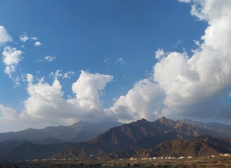 a view of mountains and clouds in the sky