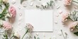 © AkuAku - Top view of blank paper wedding invitation card mockup with white card and flowers featuring ample copy space