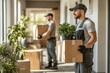© Anastasiya - Professional movers carrying boxes and plants through a well-lit modern interior during a residential move.
