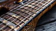 © Pongsathon - Focused image of the inlays and fret markers on a guitar neck