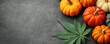 © Mongkol - Capture the essence of autumn with this vibrant background featuring gourds and cannabis leaves, perfect for seasonal designs and marketing materials.