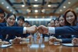 © Yuliia - Beautiful businesspeople making a fist bump over the desk in a show of camaraderie and teamwork.