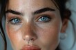 © Silvana - A professional close-up photo of a woman with an eyebrow piercing, featuring her intense gaze and subtle smile. The focus is sharp on her eyes and the small gold eyebrow stud