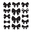 © KARIB - A collection of black bows with varying sizes and shapes. The bows are all black and are arranged in a row with white background