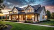 © sawaratch - Beautiful modern farmhouse home exterior at dusk with lights on and green grass, architectural photography
