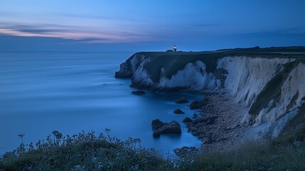 Wall Mural - Serene twilight view of a coastal cliff with a lighthouse overlooking the ocean