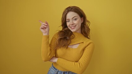 Poster - Young caucasian woman wearing sweater standing smiling happy pointing with hand and finger to the side over isolated yellow background