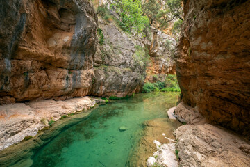 View of a stretch of the impressive Ebron river strait, Teruel, Aragon, Spain, between high rock walls and turquoise waters with walkways for hikers