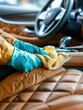 © Anat art - A person cleans and polishes the leather seats of a car using a cloth, showcasing attention to detail in maintaining the vehicle's interior. Generative AI